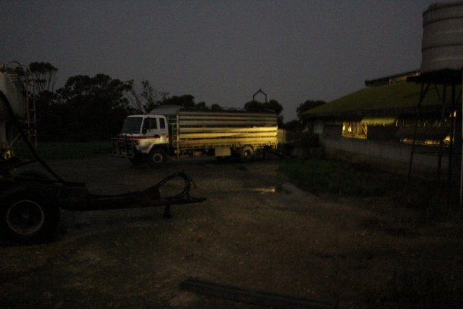 Truck backed up to sheds outside