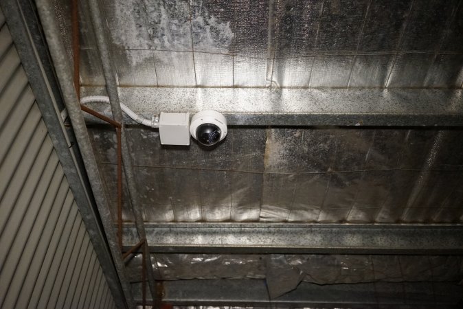 Security surveillance camera watching over holding pens and race