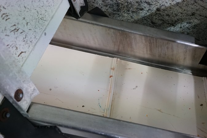 Conveyor belt leading into macerator