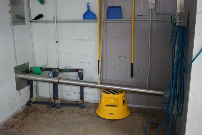 Pipe leading from macerator room (right) to dumpster outside (left)
