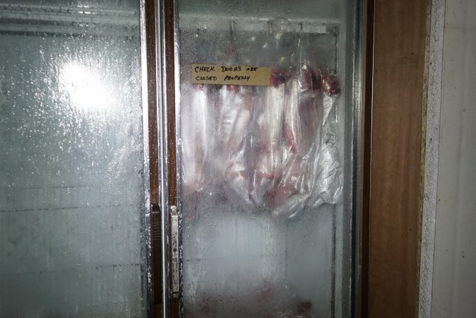 Slaughtered and skinned rabbits hanging in home slaughterhouse