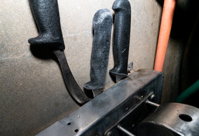 Knives in cattle processing room