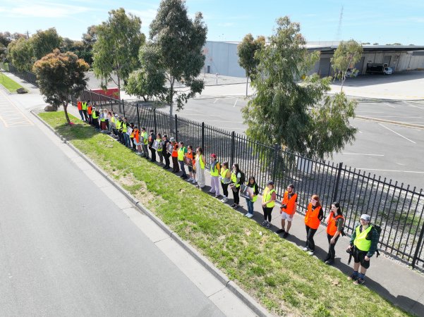 Drone shot of activist standing in line, outside of Diamond Valley Pork