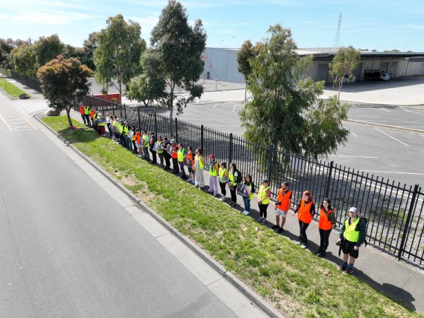 Drone shot of activist standing in line, outside of Diamond Valley Pork