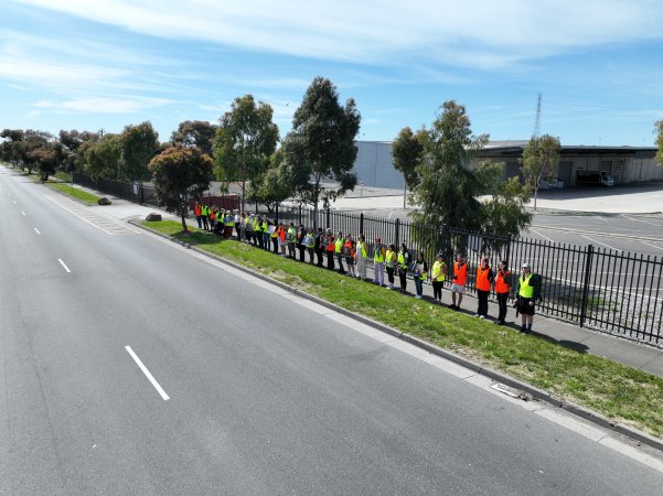 Drone shot of activist standing in line, outside of Diamond Valley Pork