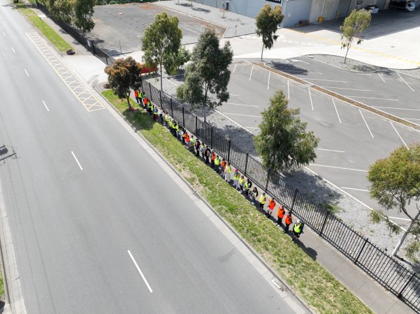 Drone shot of activist standing in line, outside of Diamond Valley Pork