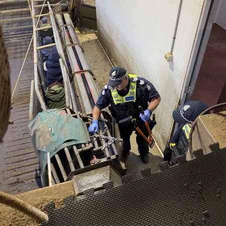 Police officer prepares to bolt-cut chains