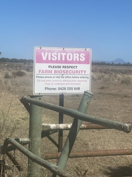 Sign at entrance by dirt road