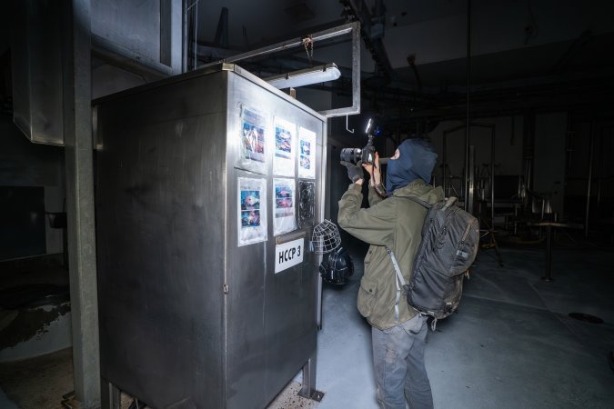 Investigator films knockbox inside cattle processing room