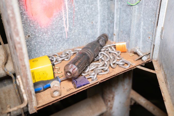 Handheld bolt gun in box near holding pens