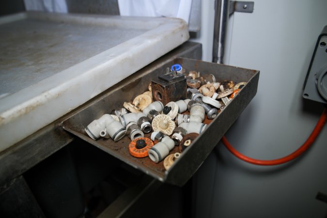 Tray containing ear tags next to knock box