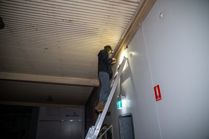 Investigator looks for places to install hidden cameras