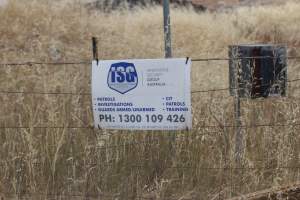 Security warning on perimeter fence - Australian pig farming - Captured at Corowa Piggery & Abattoir, Redlands NSW Australia.