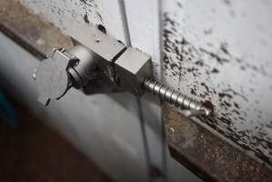 Lock on door of sealed maceration room - Key inserted. Key can either be in door, or in control panel to turn on macerator, so that theoretically the door cannot be open while the macerator is on. - Captured at SBA Hatchery, Bagshot VIC Australia.