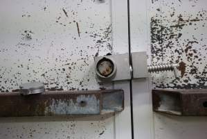 Lock on door of sealed maceration room - Key removed. Key can either be in door, or in control panel to turn on macerator, so that theoretically the door cannot be open while the macerator is on. - Captured at SBA Hatchery, Bagshot VIC Australia.