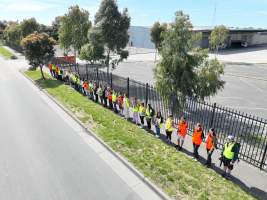 Drone shot of activist standing in line, outside of Diamond Valley Pork - Taken at Diamond Valley Pork as part of the Melbourne Vegan Takeover - Day of Action for Animals - Captured at Diamond Valley Pork, Laverton North VIC Australia.