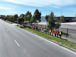 Drone shot of activist standing in line, outside of Diamond Valley Pork - Taken at Diamond Valley Pork as part of the Melbourne Vegan Takeover - Day of Action for Animals - Captured at Diamond Valley Pork, Laverton North VIC Australia.