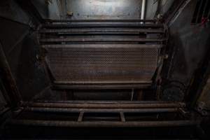 Gondolas inside gas chamber - Gondola inside the Butina combi gas chamber. View from floor of kill room looking into chamber - Captured at Benalla Abattoir, Benalla VIC Australia.