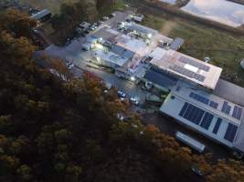 Aerial view of activists on roof of slaughterhouse - Activists shut down Benalla Slaughterhouse, with massive Stop Gassing Pigs for Pork banner on rooftop - Captured at Benalla Abattoir, Benalla VIC Australia.