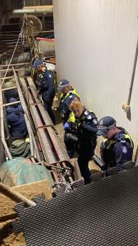 Police speak with activists chained inside race - Activists shut down Benalla slaughterhouse.
Photo by Catriona Marshall. - Captured at Benalla Abattoir, Benalla VIC Australia.