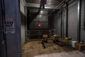 Outside the bottom of the gas chamber - The bottom of the gas chamber, sitting within an open maintenance room. To the left, a sign reads 'Danger - Keep Out - Authorised Personnel Only'. - Captured at Corowa Slaughterhouse, Redlands NSW Australia.