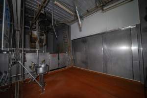 Upper level of cattle kill room - Shackled cows are hoisted from the floor below and moved through the swinging doors - Captured at Gathercole's Wangaratta Abattoir, Wangaratta VIC Australia.