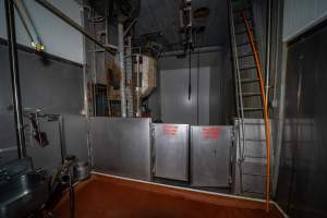 Upper level of cattle kill room - Shackled cows are hoisted from the floor below and moved through the swinging doors - Captured at Gathercole's Wangaratta Abattoir, Wangaratta VIC Australia.