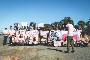 Animal activists asking for the release of Olivia (sow 8416) at Midland Bacon in Victoria - Image taken outside Midland Bacon, where a worker was filmed r*ping sow 8416 (now named Olivia) while she was trapped inside her farrowing crate. This day of action was part of the campaign to Free Olivia. - Captured at Midland Bacon, Carag Carag VIC Australia.