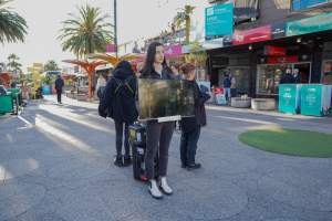5 Question Challenge: Dominion Outreach Melbourne: 15 June 2025 - Animal rights activists participating in a street outreach event in St Kilda, Victoria, Australia. Some volunteers hold placards inviting pedestrians to answer 5 questions in exchange for a vegan treat. Others hold TVs showing footage from Farm Transparency Project’s dairy investigations. Together, they bring awareness to the hidden reality of what happens to cows, calves, and bulls in the Australian dairy industry. - Captured at VIC.