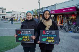 5 Question Challenge: Dominion Outreach Melbourne: 15 June 2025 - Animal rights activists participating in a street outreach event in St Kilda, Victoria, Australia. Some volunteers hold placards inviting pedestrians to answer 5 questions in exchange for a vegan treat. Others hold TVs showing footage from Farm Transparency Project’s dairy investigations. Together, they bring awareness to the hidden reality of what happens to cows, calves, and bulls in the Australian dairy industry. - Captured at VIC.