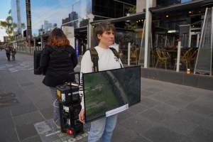 22 June 2025: 5 Question Challenge: Dominion Outreach Melbourne - Animal rights activists participating in a street outreach event in Southbank, Victoria, Australia. Some volunteers hold placards inviting pedestrians to answer 5 questions in exchange for a vegan treat. Others hold TVs showing footage from Farm Transparency Project’s dairy investigations. Together, they bring awareness to the hidden reality of what happens to cows, calves, and bulls in the Australian dairy industry. - Captured at VIC.
