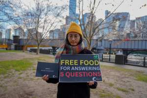 22 June 2025: 5 Question Challenge: Dominion Outreach Melbourne - Animal rights activists participating in a street outreach event in Southbank, Victoria, Australia. Some volunteers hold placards inviting pedestrians to answer 5 questions in exchange for a vegan treat. Others hold TVs showing footage from Farm Transparency Project’s dairy investigations. Together, they bring awareness to the hidden reality of what happens to cows, calves, and bulls in the Australian dairy industry. - Captured at VIC.