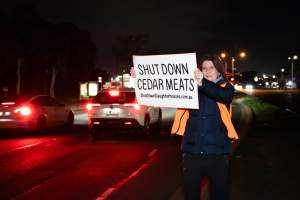 Cedar Meats Vigil - National Week Of Action 2025 - During the Shut Down Slaughterhouses Week of Action, we held a vigil outside of the Cedar Meats slaughterhouse in Brooklyn, Victoria.

During a two week investigation last year, our hidden cameras captured the handling and slaughter of animals, including newborn lambs and kids born in the holding pens of the slaughterhouse.

It was a Wednesday night when we gathered outside the slaughterhouse, holding signs and listening to music and speeches from investigators. We wanted to send a message to Cedar Meats, to let them know that we have not forgotten how they treat animals when they believe that no one is watching

We poured fake blood across their driveway as a visual reminder to everyone passing by, that animals arriving here are coming to their deaths. At the gates to the slaughterhouse, we each left a flower.

The images of animals whose deaths we have seen will haunt us forever, but we are determined to continue to fight in their name. - Captured at Cedar Meats, Brooklyn VIC Australia.