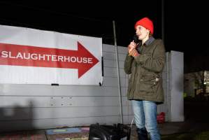 Cedar Meats Vigil - National Week Of Action 2025 - During the Shut Down Slaughterhouses Week of Action, we held a vigil outside of the Cedar Meats slaughterhouse in Brooklyn, Victoria.

During a two week investigation last year, our hidden cameras captured the handling and slaughter of animals, including newborn lambs and kids born in the holding pens of the slaughterhouse.

It was a Wednesday night when we gathered outside the slaughterhouse, holding signs and listening to music and speeches from investigators. We wanted to send a message to Cedar Meats, to let them know that we have not forgotten how they treat animals when they believe that no one is watching

We poured fake blood across their driveway as a visual reminder to everyone passing by, that animals arriving here are coming to their deaths. At the gates to the slaughterhouse, we each left a flower.

The images of animals whose deaths we have seen will haunt us forever, but we are determined to continue to fight in their name. - Captured at Cedar Meats, Brooklyn VIC Australia.