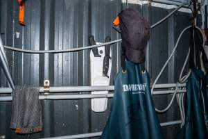 Aprons and knives on wall - Handheld photos taken at Goulburn Valley Stock Removers, owned by horse dealer Peter Loffel. Ex-racehorses are illegally killed on his residential property then transported to the knackery, where they are processed into pet food. The knackery also processes dead cows, mainly dairy cows. - Captured at Goulburn Valley Stock Removers, Shepparton North VIC Australia.