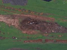 Drone flyover of dead pile at dairy farm - A pile of carcasses and skeletons of calves and cows, mixed in with dirt, on a dairy farm. - Captured at Minko North Dairy, Korunye SA Australia.